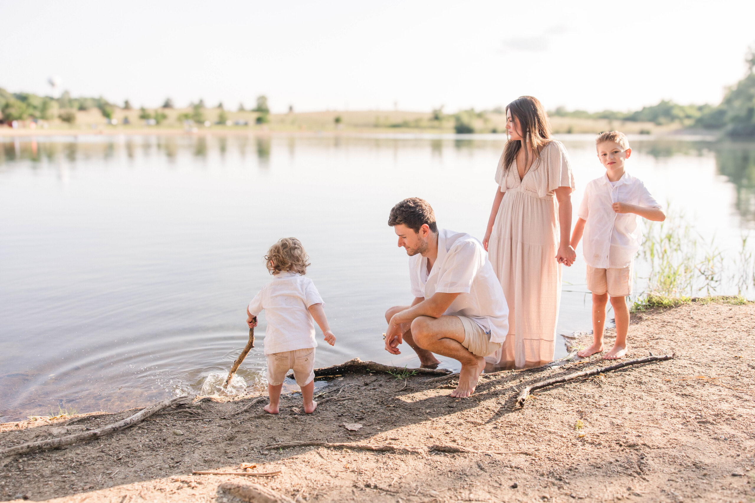 family plays in the water during photoshoot